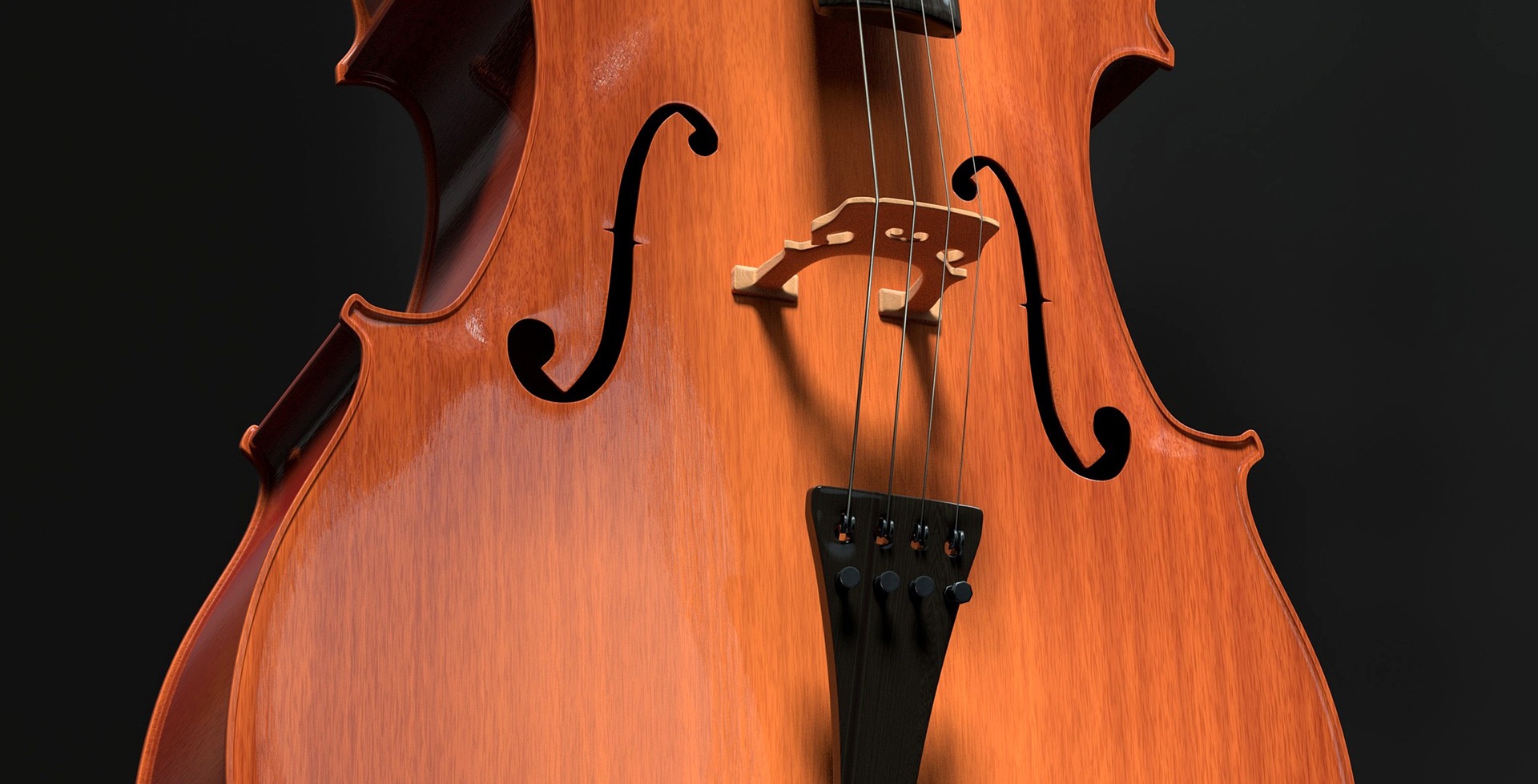 Hellbraunes Cello mit Lichtreflexen und schwarzem Hintergrund